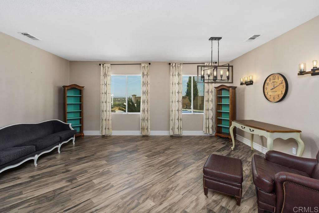 44684 Mumm Street Temecula, CA 92592 - Photo 6 of 51 a living room with furniture and a wooden floor