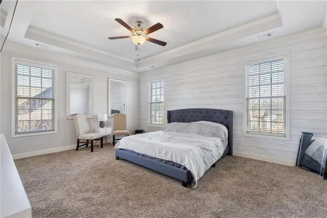 a spacious bedroom with a bed and a large window