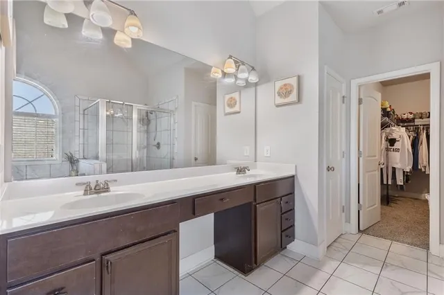 a bathroom with a sink double vanity granite and a mirror