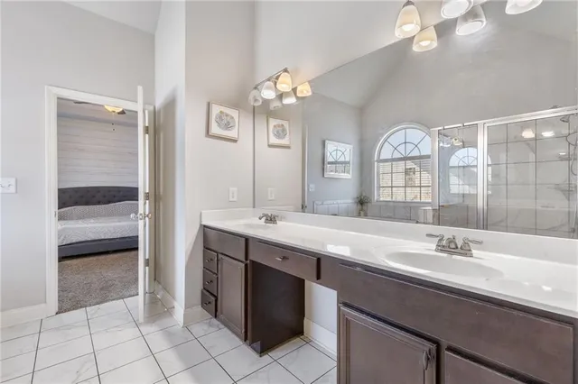 a bathroom with a sink double vanity and a mirror