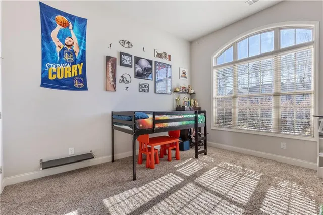 a living room with painting on the wall and a window
