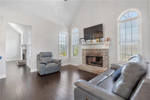 a living room with furniture fireplace and flat screen tv