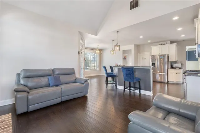 a living room with furniture and kitchen view