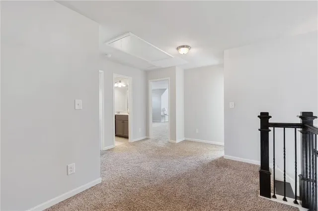 a view of a hallway with wooden shelves