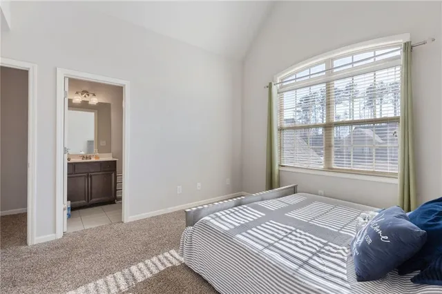 a bedroom with a bed and a view of en suite bathroom