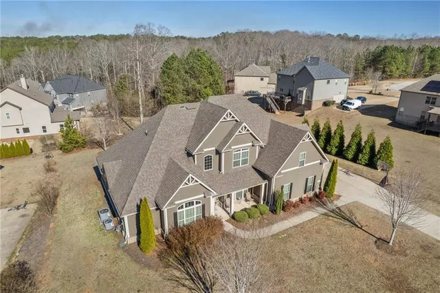 an aerial view of a house with a yard