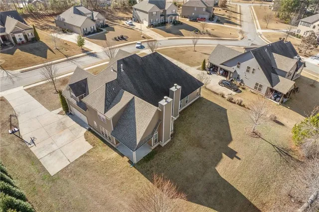 an aerial view of a house with garden space and street view