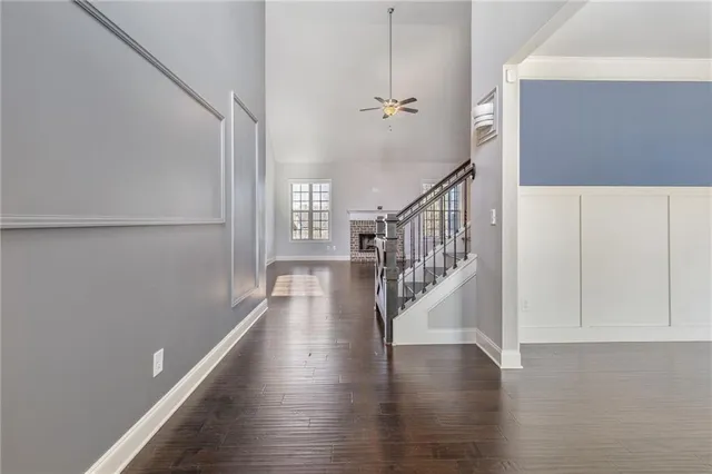 a view of entryway and hall with wooden floor