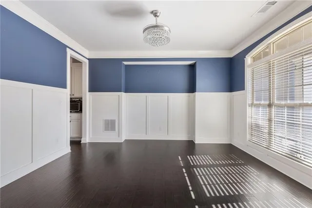 a view of wooden floor and windows in a room