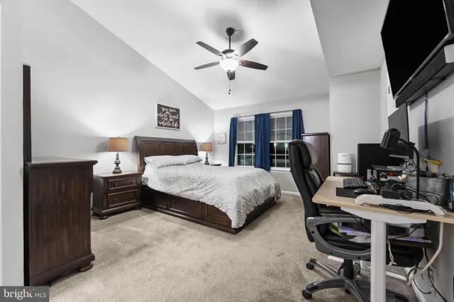 a bedroom with a bed gym equipment and a desk