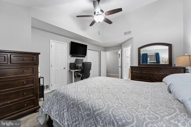 a bedroom with a bed and a television