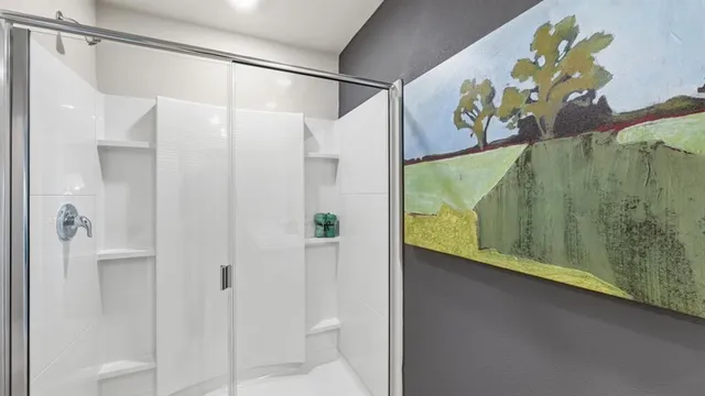 a spacious bathroom with double sink and shower