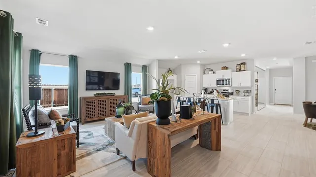 a kitchen with stainless steel appliances kitchen island granite countertop a stove and a refrigerator