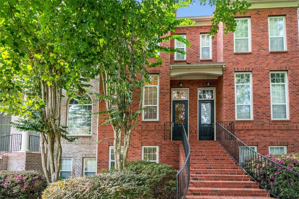 a front view of a multi story building with yard