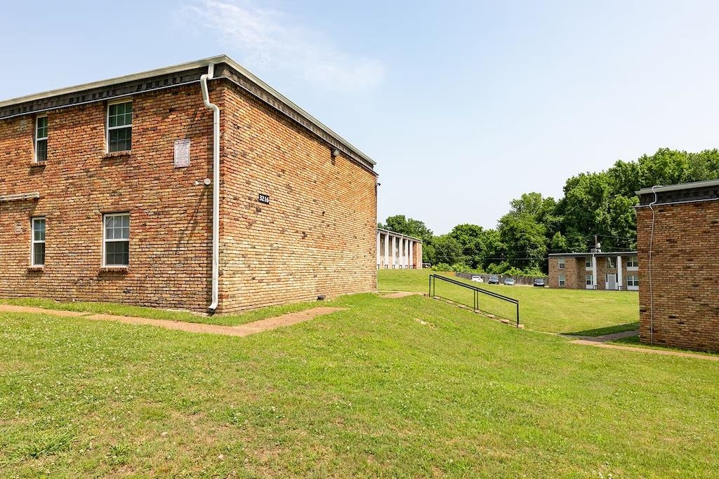 3236 Millington Road Memphis, TN 38127 - Photo 26 of 31 Brick building exterior with multiple windows and white downspouts