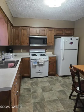 a kitchen with a stove a sink and a refrigerator