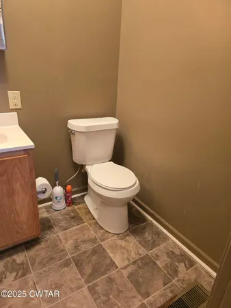a bathroom with a toilet and a mirror
