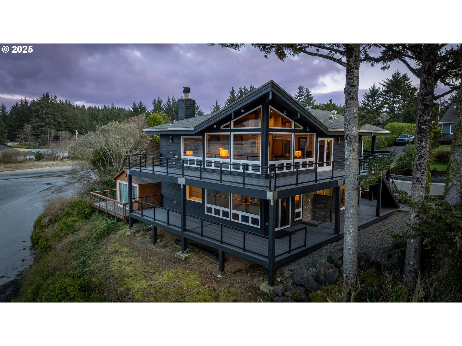 90989 Pigeon Point Loop Coos Bay, OR 97420 - Photo 16 of 48 a view of a house with wooden deck and a yard