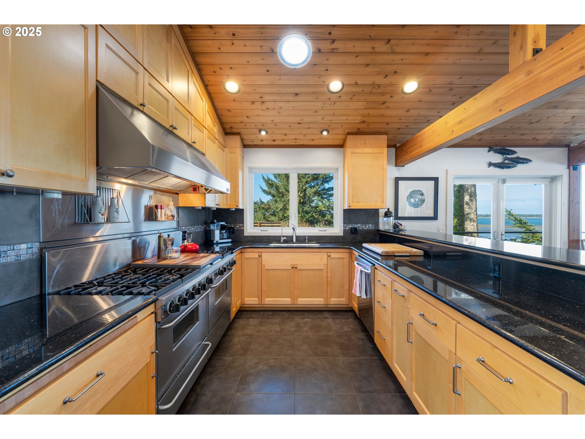 90989 Pigeon Point Loop Coos Bay, OR 97420 - Photo 20 of 48 a large kitchen with stainless steel appliances granite countertop a large stove a sink and a refrigerator
