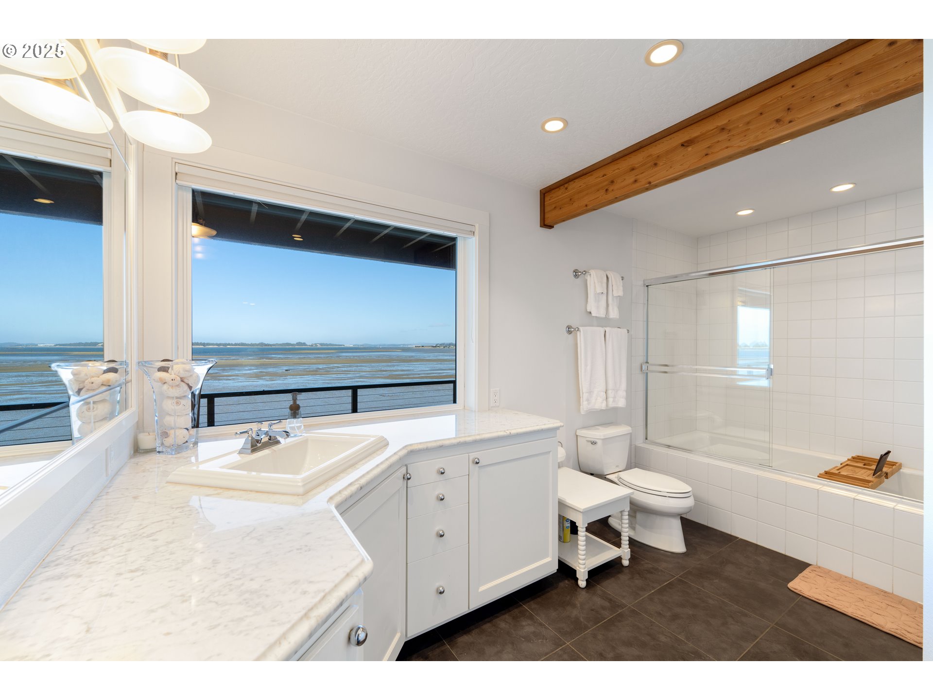 90989 Pigeon Point Loop Coos Bay, OR 97420 - Photo 38 of 48 a bathroom with a sink a toilet and a bathtub