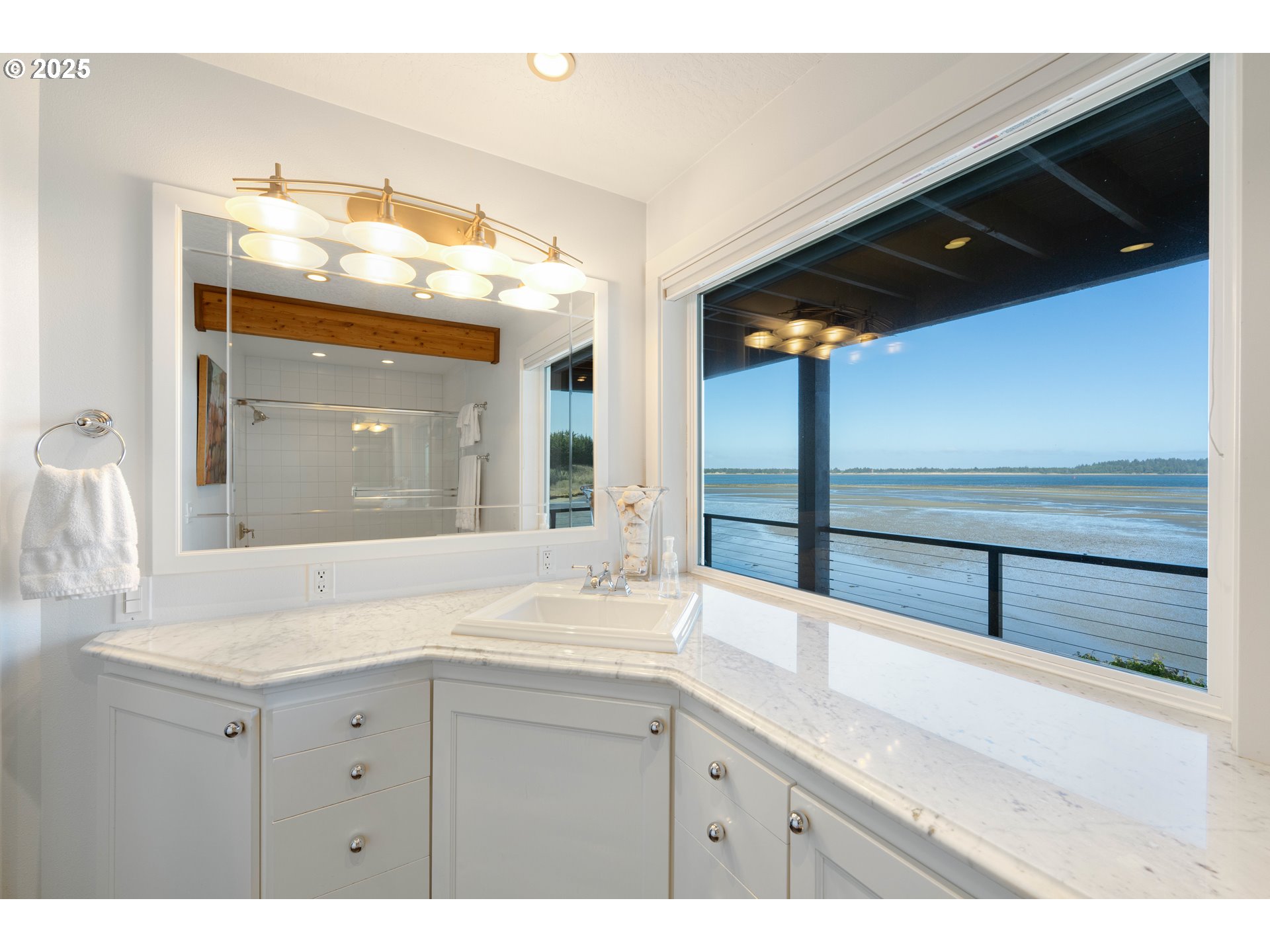 90989 Pigeon Point Loop Coos Bay, OR 97420 - Photo 39 of 48 a bathroom with a sink a vanity and a large mirror