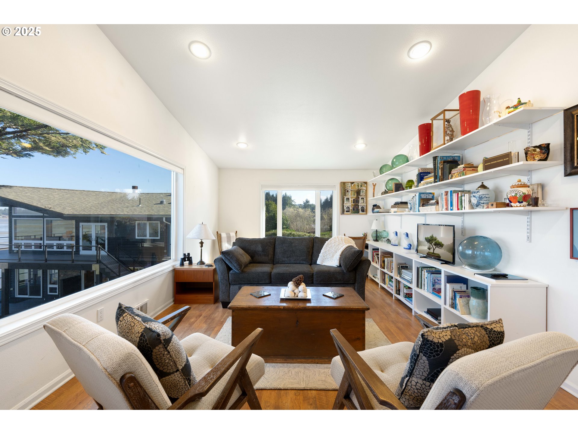 90989 Pigeon Point Loop Coos Bay, OR 97420 - Photo 43 of 48 a living room with furniture and a book shelf