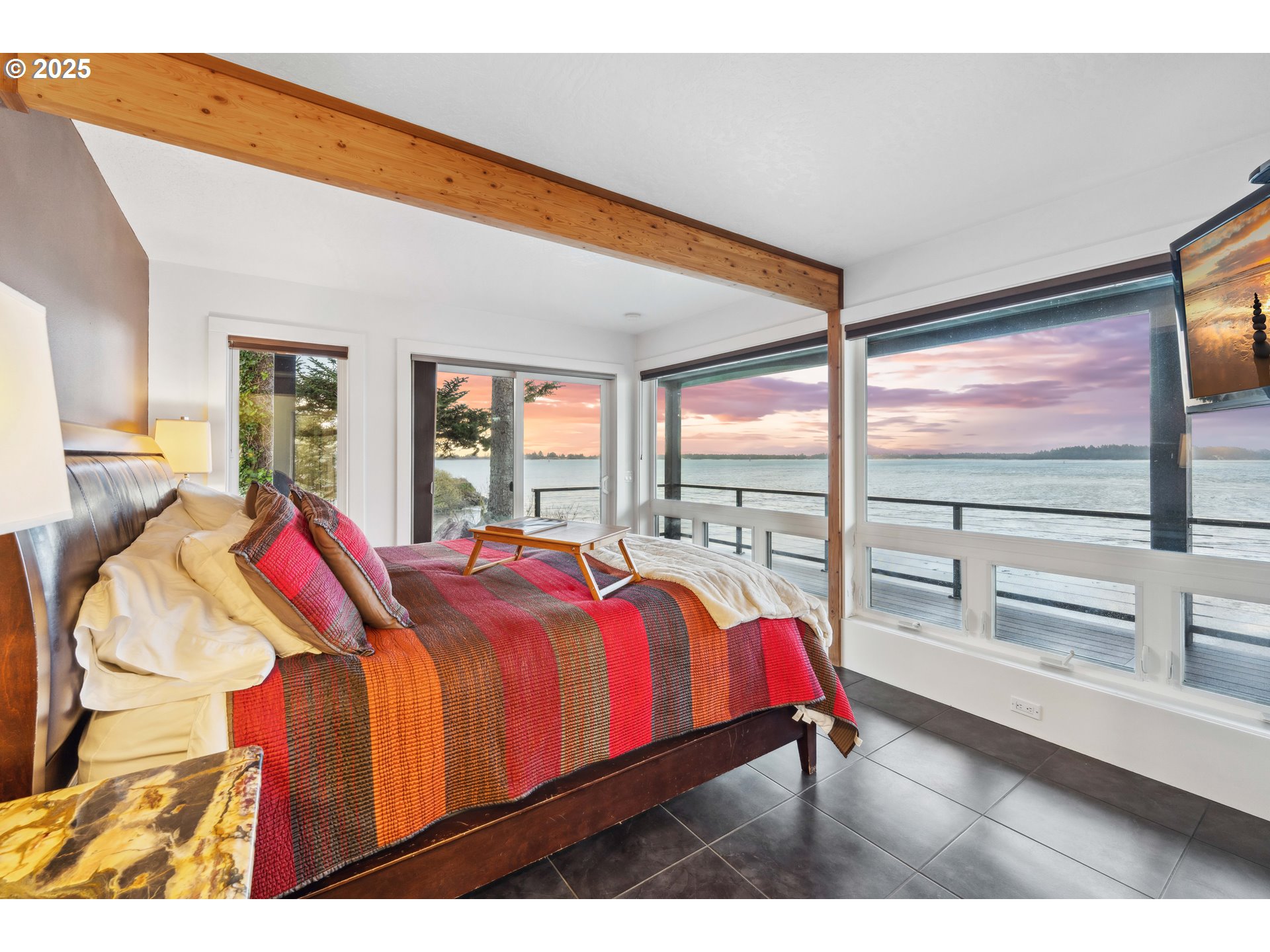 90989 Pigeon Point Loop Coos Bay, OR 97420 - Photo 5 of 48 a living room with a bed and wooden floor