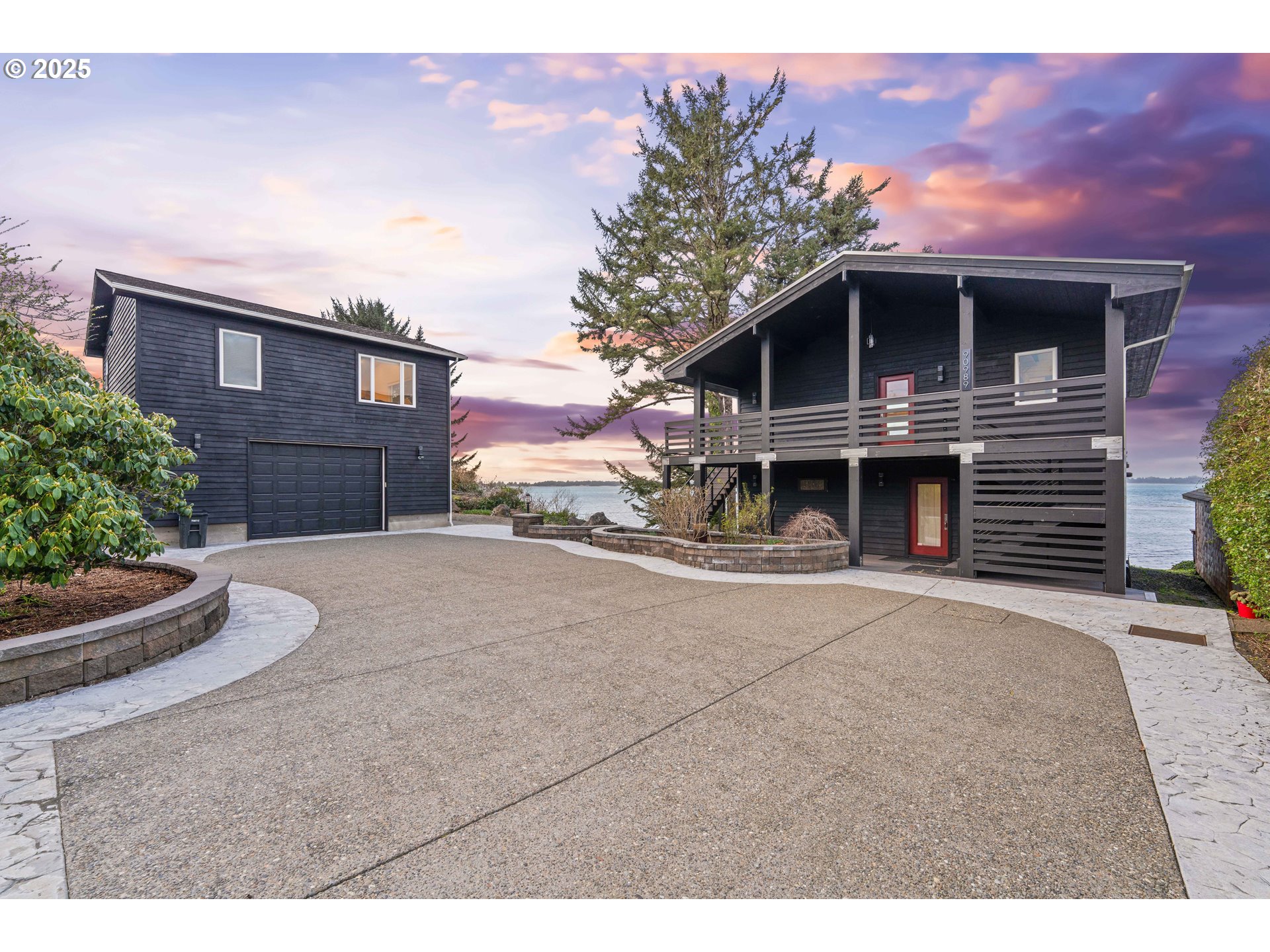 90989 Pigeon Point Loop Coos Bay, OR 97420 - Photo 10 of 48 a front view of a house with a yard and garage