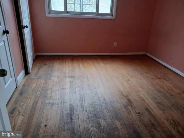 a view of room with hardwood floor and window