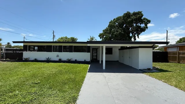 a view of a house with a backyard and a garden