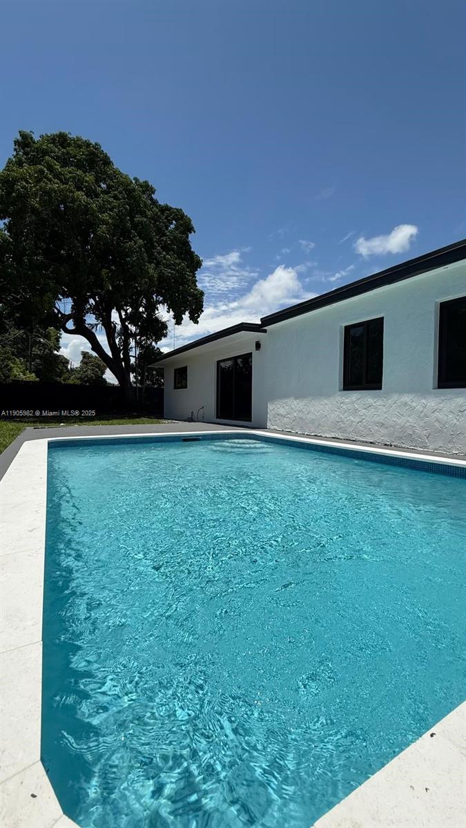 20 Northwest 197th Street Miami Gardens, FL 33169 - Photo 11 of 48 a view of a backyard with plants and a tree