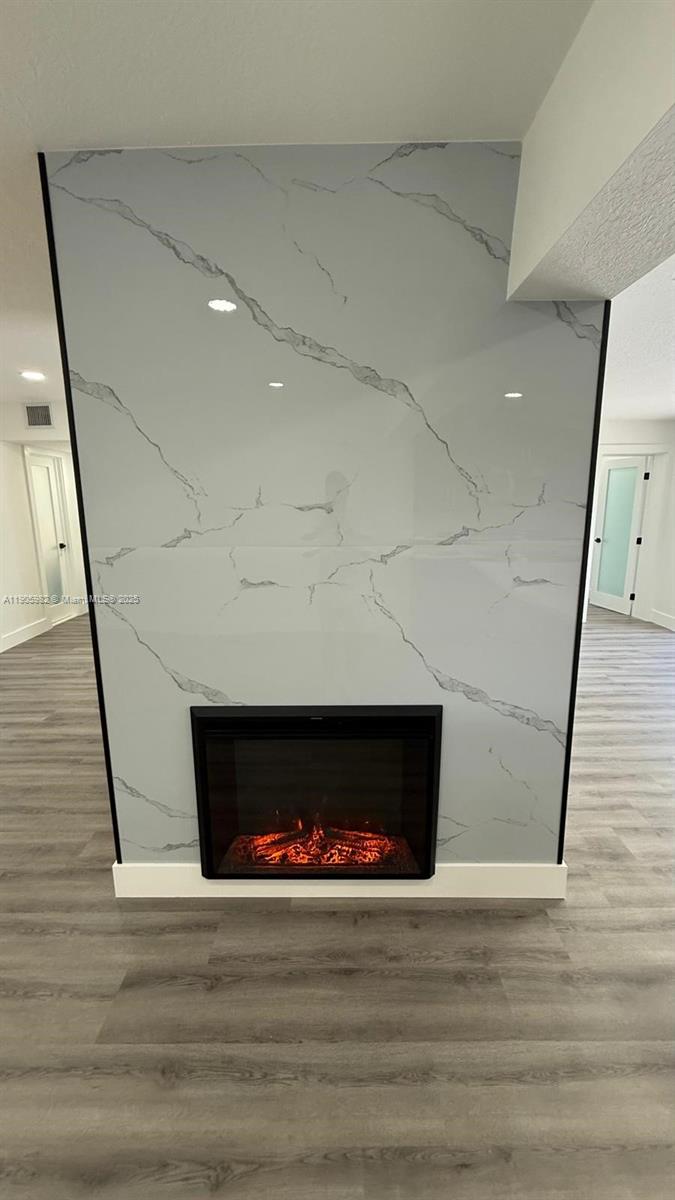 20 Northwest 197th Street Miami Gardens, FL 33169 - Photo 15 of 48 a room with a fireplace and a potted plant