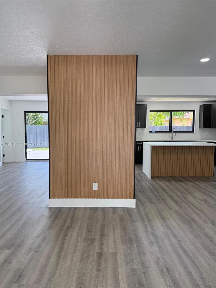 20 Northwest 197th Street Miami Gardens, FL 33169 - Photo 17 of 48 an empty room with wooden floor and windows