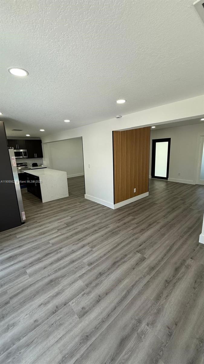 20 Northwest 197th Street Miami Gardens, FL 33169 - Photo 25 of 48 a view of an empty room with wooden floor