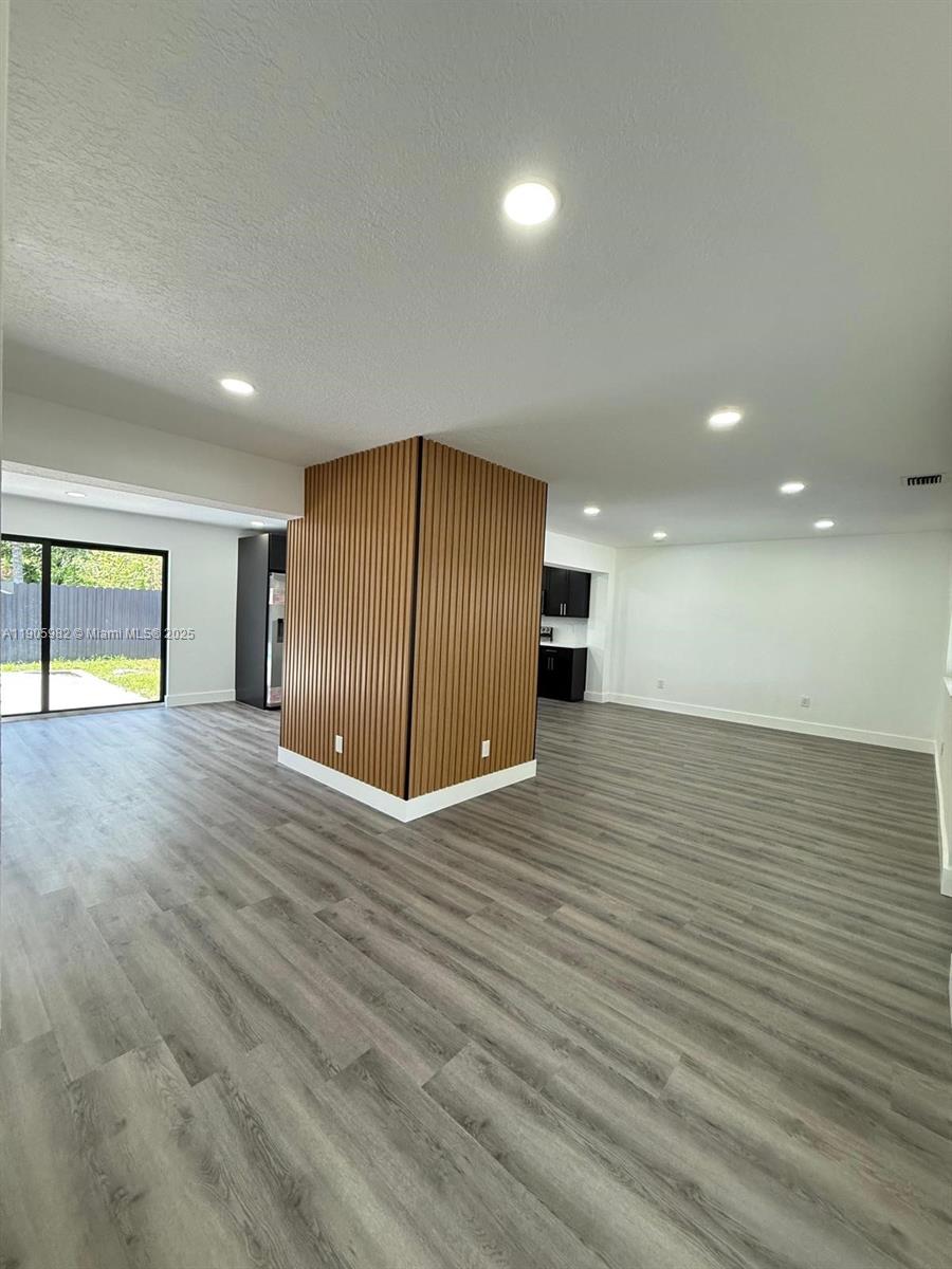 20 Northwest 197th Street Miami Gardens, FL 33169 - Photo 26 of 48 a view of an empty room with wooden floor