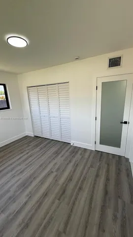 a view of an empty room and wooden floor