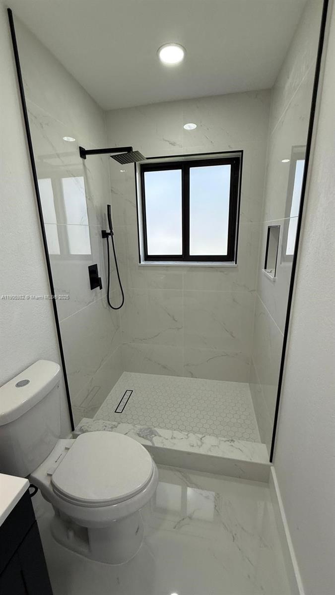 20 Northwest 197th Street Miami Gardens, FL 33169 - Photo 35 of 48 a bathroom with a toilet and a shower