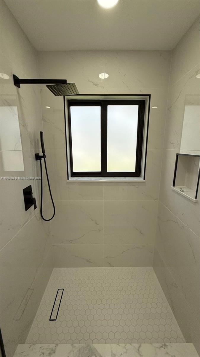 20 Northwest 197th Street Miami Gardens, FL 33169 - Photo 36 of 48 a bathroom with a glass shower door