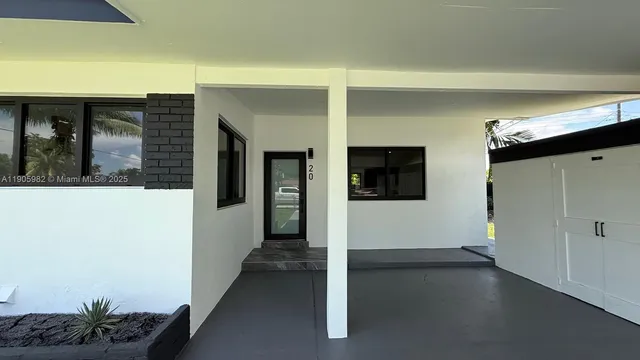 a view of a hallway with wooden floor and cabinet