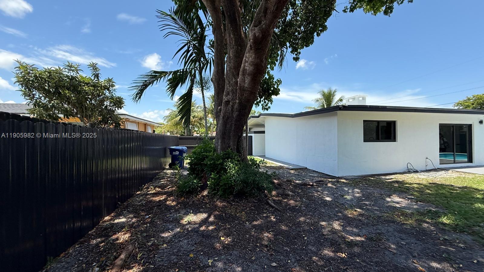 20 Northwest 197th Street Miami Gardens, FL 33169 - Photo 47 of 48 a backyard of a house with lots of green space
