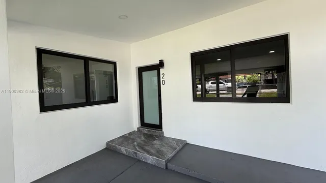 a hallway with a large mirror and door