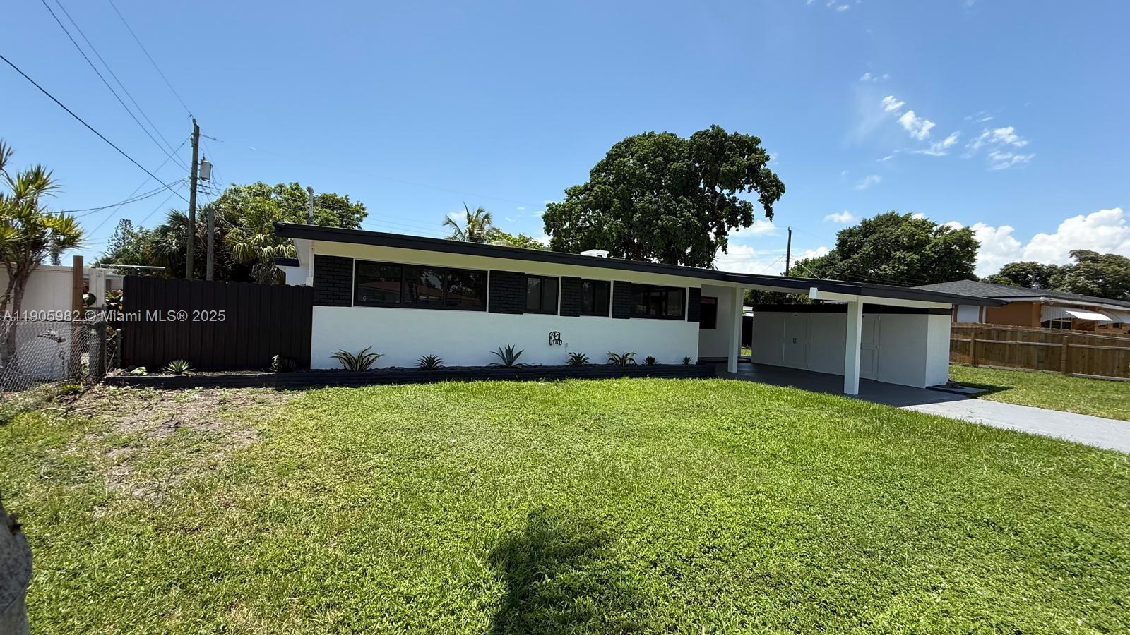 20 Northwest 197th Street Miami Gardens, FL 33169 - Photo 7 of 48 a backyard of a house with lots of green space