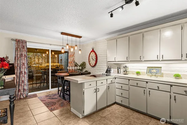 a kitchen with a sink a stove and cabinets