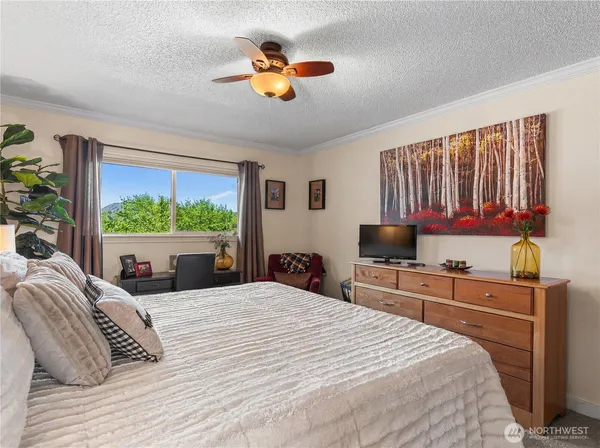 a bedroom with a large bed and a large window