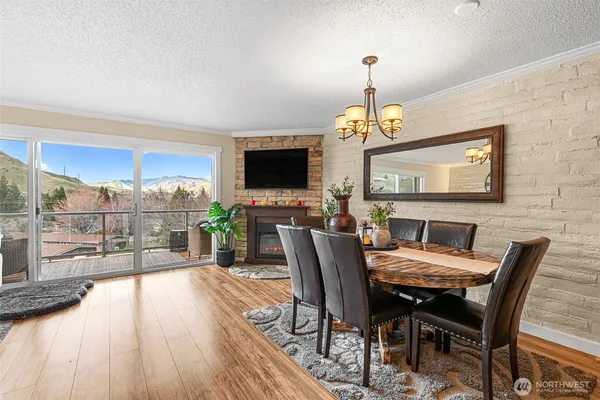 a dining room with furniture a chandelier and wooden floor