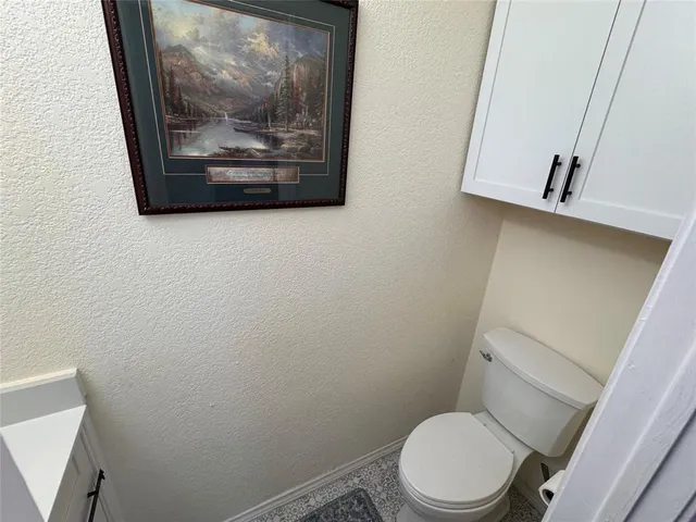 a white toilet sitting next to a small bathroom