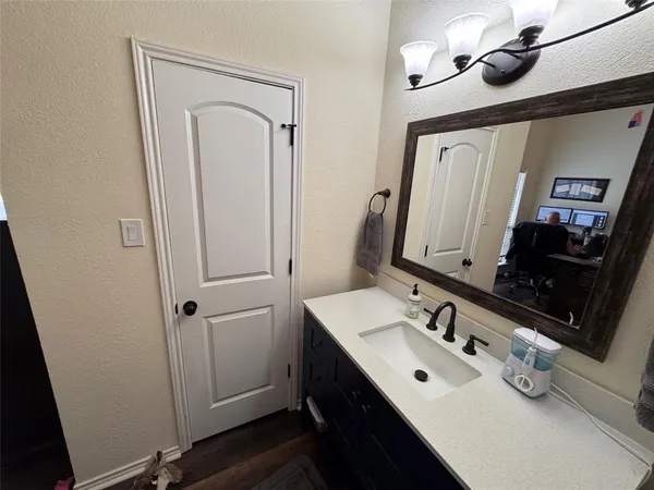 a bathroom with a sink vanity and mirror