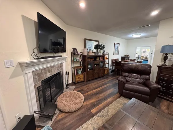 a living room with furniture a flat screen tv and a fireplace