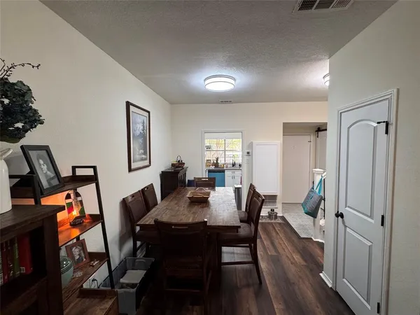 a view of a a dining room with furniture window and wooden floor