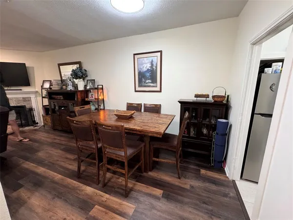 a view of a workspace with furniture and wooden floor